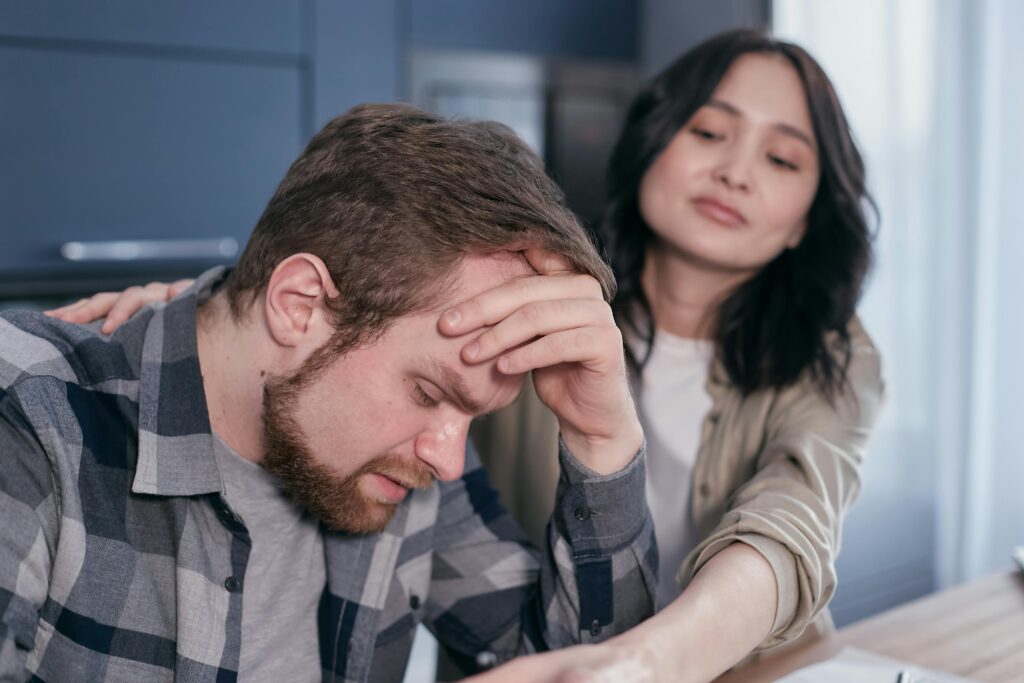 https://www.pexels.com/photo/a-woman-holding-a-stressed-man-6964126/